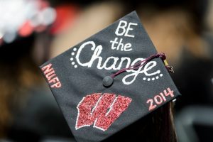 Graduates put their creativity on display with decorated and W-themed mortarboards during UW-Madison's spring commencement ceremony outdoors at Camp Randall Stadium at the University of Wisconsin-Madison on May 17, 2014. The graduation event is being held at Camp Randall for the first time in more than two decades and is expected to be attended by approximately 5,400 bachelor's and master's degree candidates and their guests. (Photo by Bryce Richter/UW-Madison)