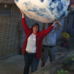 Laura Shere holding a giant inflated globe
