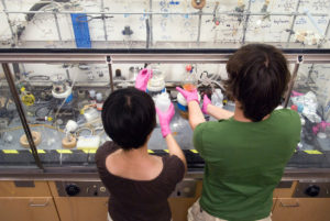 Graduate students Lingyin Li (left) and Ratmir Derda prepare materials under a fume hood in Laura L. Kiessling's research lab in the Chemistry Building at the University of Wisconsin-Madison on July 30, 2007. Kiessling is a Hilldale professor of chemistry and a Laurens Anderson professor of biochemistry.