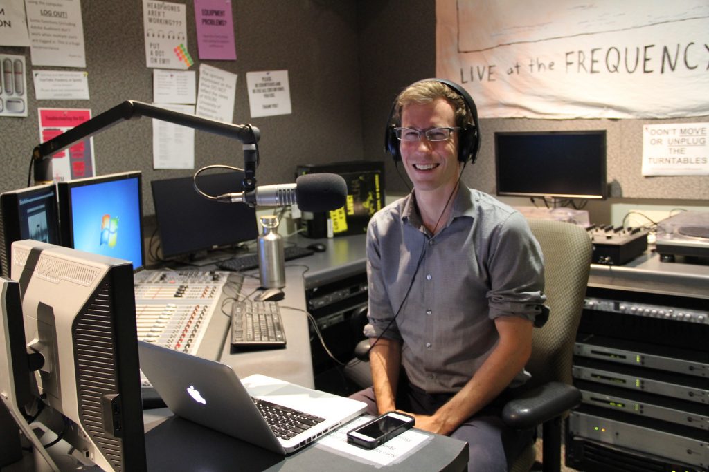 Green Fund Program Manager for the Office of Sustainability Ian Aley recording the podcast in the WSUM 91.7FM studio.