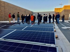 UW–Madison students and staff learning about the largest rooftop solar array in Wisconsin at Madison College.