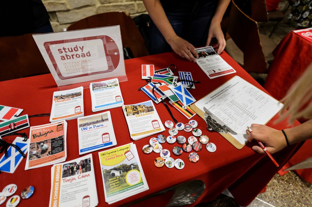 An incoming first-year undergraduate browses information tables and talks with a campus representatives about study abroad programming during a Student Orientation, Advising and Registration (SOAR) campus resource fair at Union South at the University of Wisconsin-Madison 