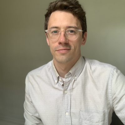 Photo of Henry Hundt in front of a plain wall