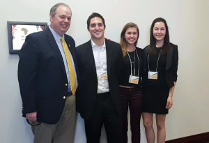 UWEC Chancellor James Schmidt poses with Nick Reitano, Megan McHenry, and Lauren Graves following their presentation of UWEC's carbon emissions study.